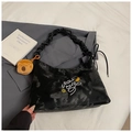 Detail of black moiré hobo bag with embroidery, ruched strap and plush bear charm - With Charm / Black