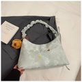 Detail of grey tie-dye moon bag with celestial embroidery and plush bear charm - With Charm / Blue