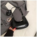 Detail of glossy black hobo bag with pearl cartoon charm and spare shoulder strap - Black with Pendant