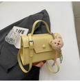 Dettaglio della borsa a tracolla gialla rettangolare con ciondolo a orsetto e nastro a righe - Giallo con Ciondolo