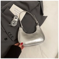 Close-up of metallic silver hobo bag with embossed lettering on a blazer background - Silver No Pendant