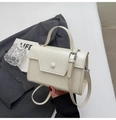 Detail of a cream leather crossbody bag featuring a textured flap and stylish metal buckle - Rice White (No Pendant)