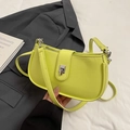 Lime green crescent shoulder bag with pebbled leather texture and silver buckle detail - Oriole Green