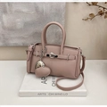 Detail of lychee pattern leather handbag with silver lock and heart charm on books - Sakura Pink With Charm