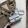 Light blue crossbody handbag with silver metal lock on a stylish lifestyle background - Blue (Without Charm)