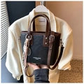 Detail of oil wax leather bucket bag with tennis racket charm and decorative pendant - Black