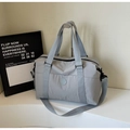 Close-up of waterproof grey fabric and embossed round logo on the travel tote bag - Gray