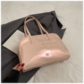 Metallic light pink tote bag with front pocket and metal logo on a grey blazer background - Pink Without Pendant