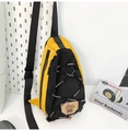Close-up of yellow and black outdoor chest bag with SPORTS elastic cords and brand logo - Yellow Black