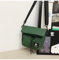Dettaglio della borsa a tracolla in nylon verde scuro con patta e cordini a righe - Verde