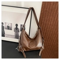 Detail of adjustable silver buckle and metal chain on a brown vintage leather hobo bag - Brown