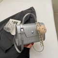 Chic silver pleated crossbody bag with a brown plush bear charm and thin strap - With Pendant / Silver