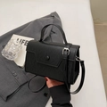 Elegant black lychee textured leather crossbody bag with top handle and round buckle - No Pendant / Black