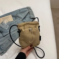 Khaki nylon mini drawstring crossbody bucket bag with adjustable black cord shoulder strap - Khaki