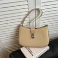 Beige woven hobo bag with silver clasp and slim leather strap in a minimalist setting - Khaki