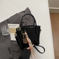 Glossy black leather bucket bag with metallic charms and woven rope detail - Black With Pendant
