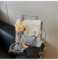 Silver mini shoulder bag with decorative buckles and brown plush bear charm detail - With Charm / Silver