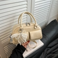 Cream yellow mini bowling handbag with lace pearl bow charm and dual front pockets - White with Pendant