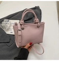 Close-up of pink litchi pattern bucket bag with knot handle and silver eyelets - No Pendant / Purple