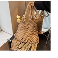 Detailed shot of beige woven straw handbag featuring hollow mesh design and long fringe tassels - Khaki