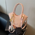 Rosafarbene geflochtene Beuteltasche mit gewelltem Rand, Doppelgriffen und Schultergurt - Mit Anhänger / Rosa