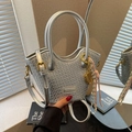Silver woven crossbody bucket bag with top handle and decorative knot charm detail - With Charm / Silver