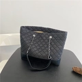 Detail of black quilted nylon tote bag with silver chain strap and leather base - Black Oxford Cloth