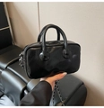 Close-up of black glossy leather Boston bag with chain strap and silver zipper detail - Black
