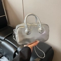 Silver metallic bowling bag with round handle joints and slim chain strap in hand - Silver