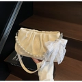 Detail of cream pleated cloud bag with pearl chain and lace bow on wooden stairs - Off-white