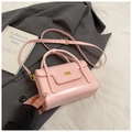 Pink minimalist handbag with golden logo on gray blazer and book background - Pink Without Pendant