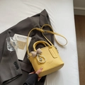 Bright yellow pebbled leather bucket bag with elegant bow and heart pearl pendant - Yellow with Pendant