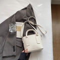 White lychee grain leather bucket bag with handle and shoulder strap on a grey suit jacket - Off-white Without Pendant