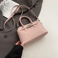 Roze Kelly-handtas met litchi-textuur, zilveren draaislot en verstelbare schouderriem - Zonder hanger / Roze