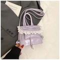 Close-up of lavender mini backpack with white lace trim and leather bow detail - Purple