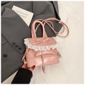 Detailed view of pink mini backpack with white lace trim and elegant bow detail - Pink