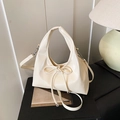 Chic beige bucket handbag with bow detail and adjustable crossbody strap for women - Off White