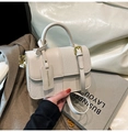 Modern cream contrast crossbody bag featuring woven texture and decorative buckle detail - White