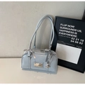 Detail view of light blue patent leather Boston bag with ribbon bows and silver charms - Blue with Charm