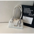 Detail of white glossy leather shoulder bag featuring silver logo and heart charm - Cream White With Pendant