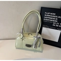 Close-up of pistachio green patent leather pillow bag with metal logo and ribbon detail - Green with Pendant