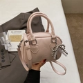Pink Boston style handbag with pearl bow charm and heart detail on shiny leather surface - With Pendant / Pink