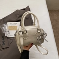 Creamy white patent leather pillow bag with silver bow charm and heart stitching - With Pendant / Off White