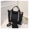 Versatile black canvas tote bag featuring white printed straps and brown leather patch - Black