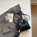 Minimalist black litchi grain bucket bag with knotted handles and adjustable strap - Black without Pendant