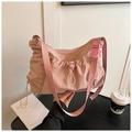 Detail view of pink nylon tote bag featuring drawstring pleats and adjustable strap - Pink