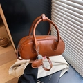 Brown vintage leather bowling bag with top handles, heart charm, and adjustable strap - Brown