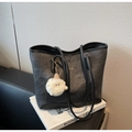 Detail of black matte tote bag with gold logo and a white plush lamb charm on a book - Dark Brown (With Pendant)