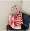 Detailed close-up of a red and white striped canvas tote bag resting on a chair - Fine Red Stripe