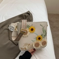 White faux leather shoulder bag with floral sunflower embroidery and ethnic woven strap - Off White